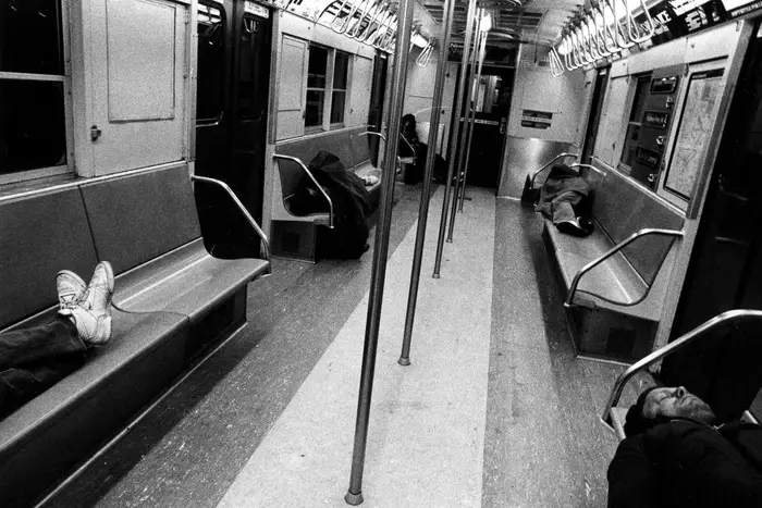 A typical late night street scene in Manhattan during the 1980's was the frequent sight of homeless people, such as these on the "L" train.